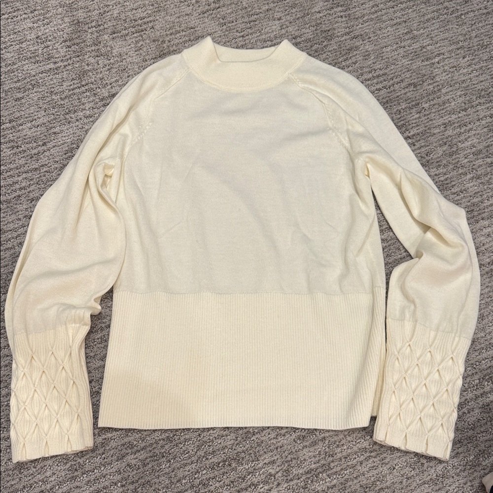 Ellie Tahari cream-colored sweater with fun details on sleeves